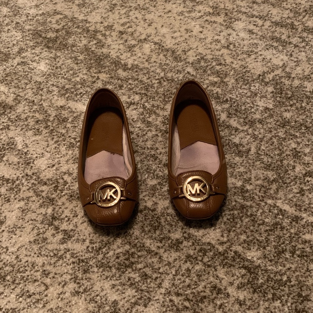 Women’s Michael Kors brown flats with gold emblem